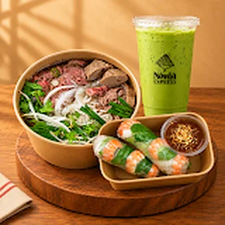Phở, summer rolls and Thai green milk tea Rare beef phở with summer rolls, peanut dip and a Thai green milk tea from Nón Lá Express Flushing