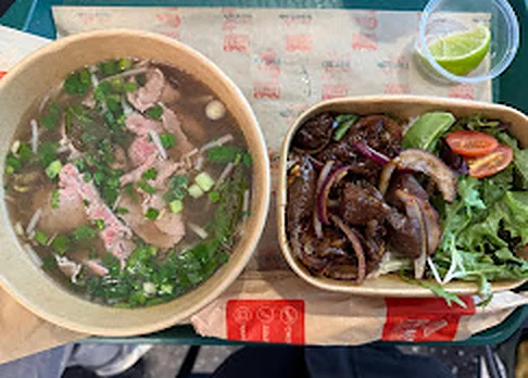 Beef phở and shaking beef - Flushing Vietnamese Bowl of rare beef phở next to shaking beef with red onions at Nón Lá Express in Flushing