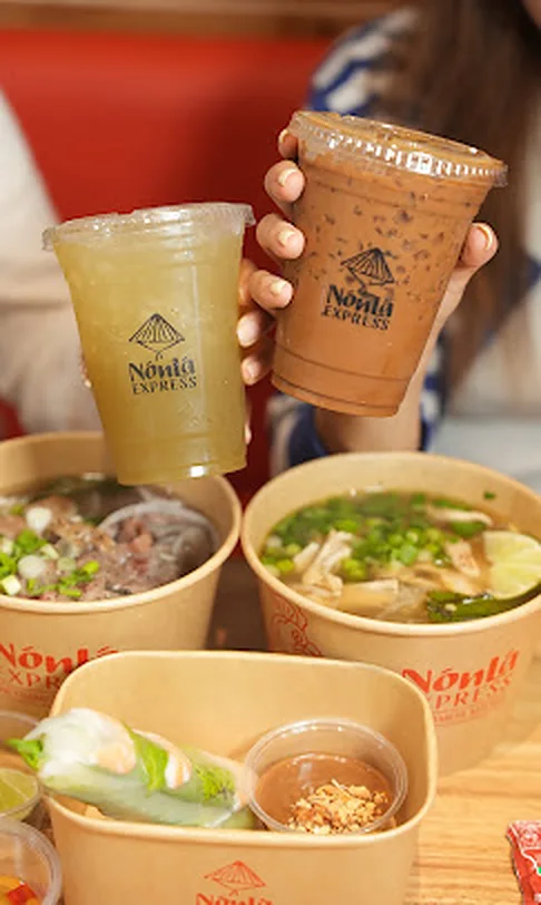 Sugarcane juice and Vietnamese iced coffee held over phở bowls at Nón Lá Express, Tangram Flushing